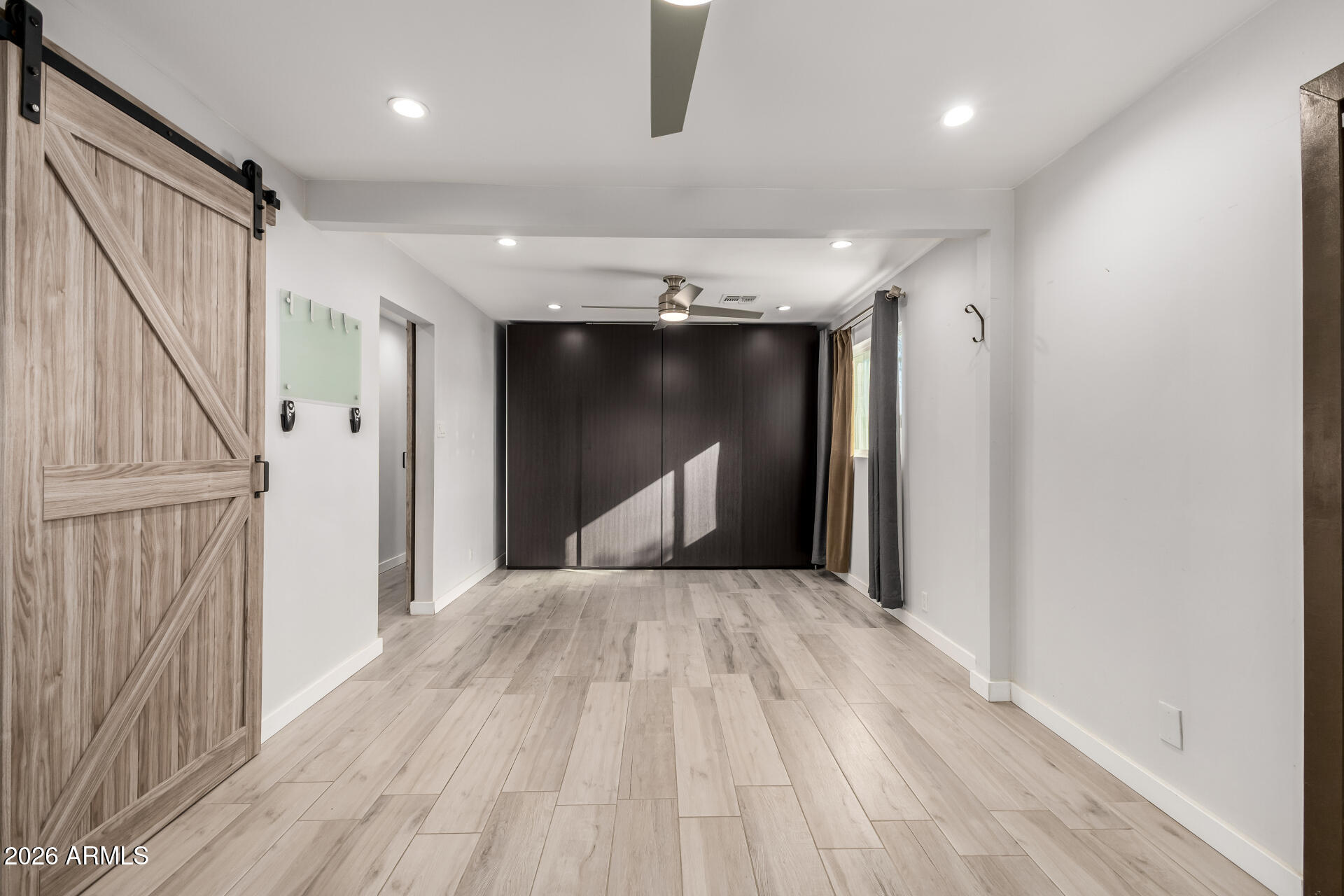 2402 North 37th Street Phoenix, AZ 85008 - Photo 25 of 44 a view of empty room with wooden floor