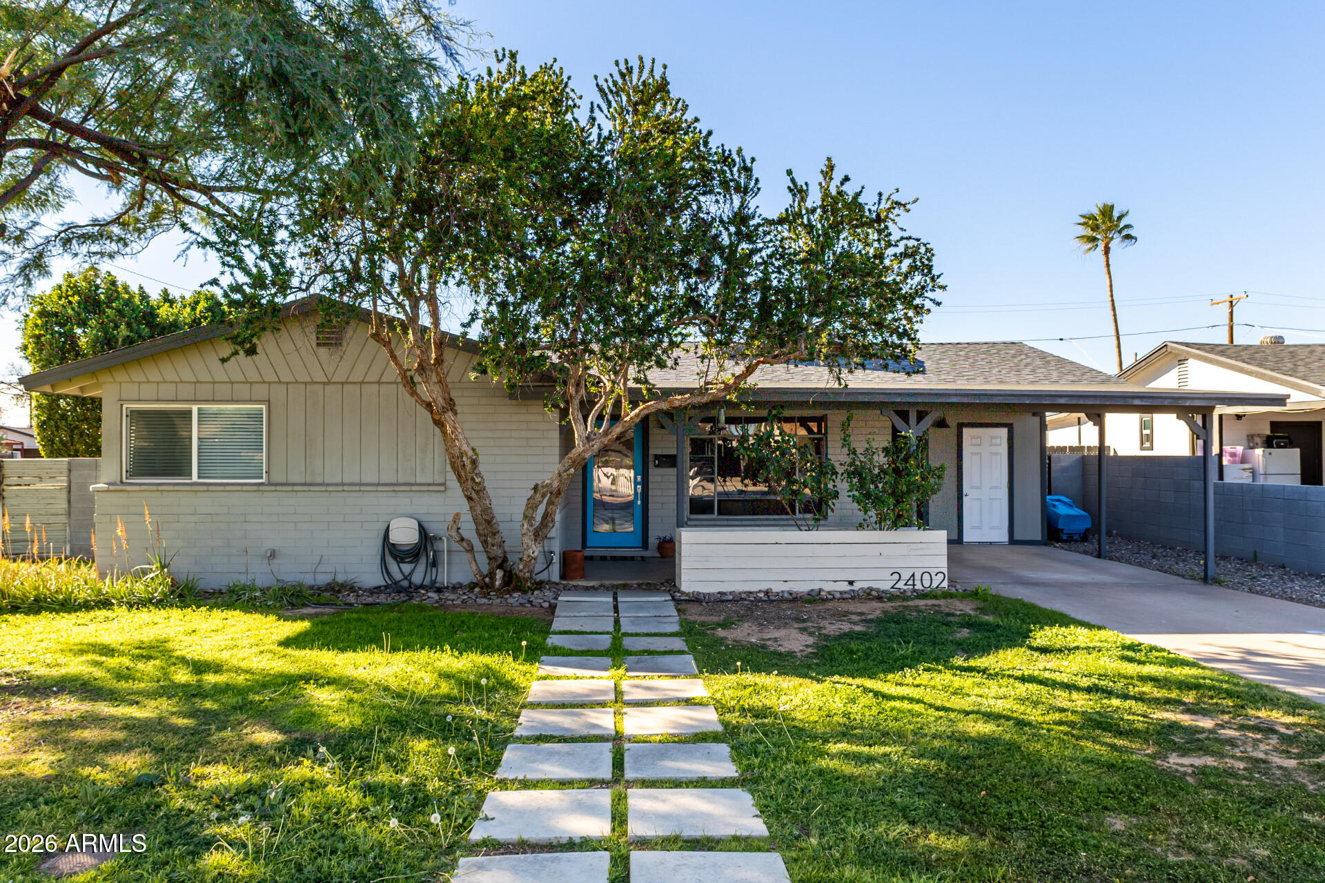 2402 North 37th Street Phoenix, AZ 85008 - Photo 39 of 44 a front view of a house with a yard table and chairs