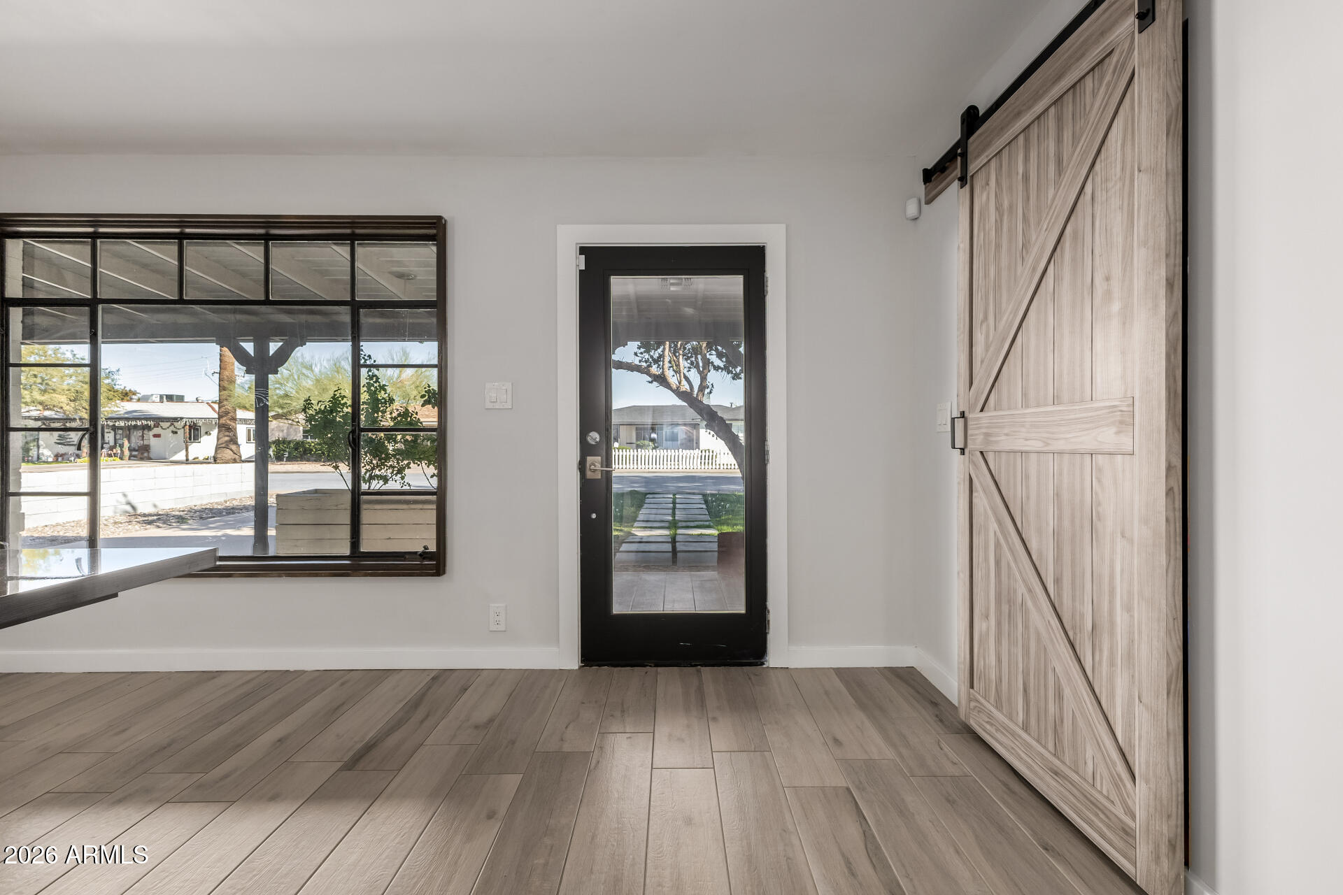 2402 North 37th Street Phoenix, AZ 85008 - Photo 4 of 44 an empty room with wooden floor and windows