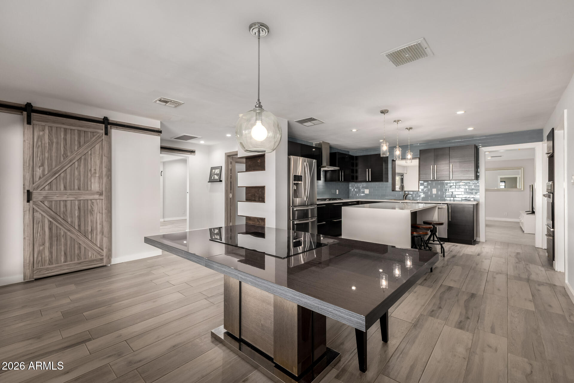 2402 North 37th Street Phoenix, AZ 85008 - Photo 8 of 44 a kitchen with stainless steel appliances granite countertop a sink refrigerator and wooden floor