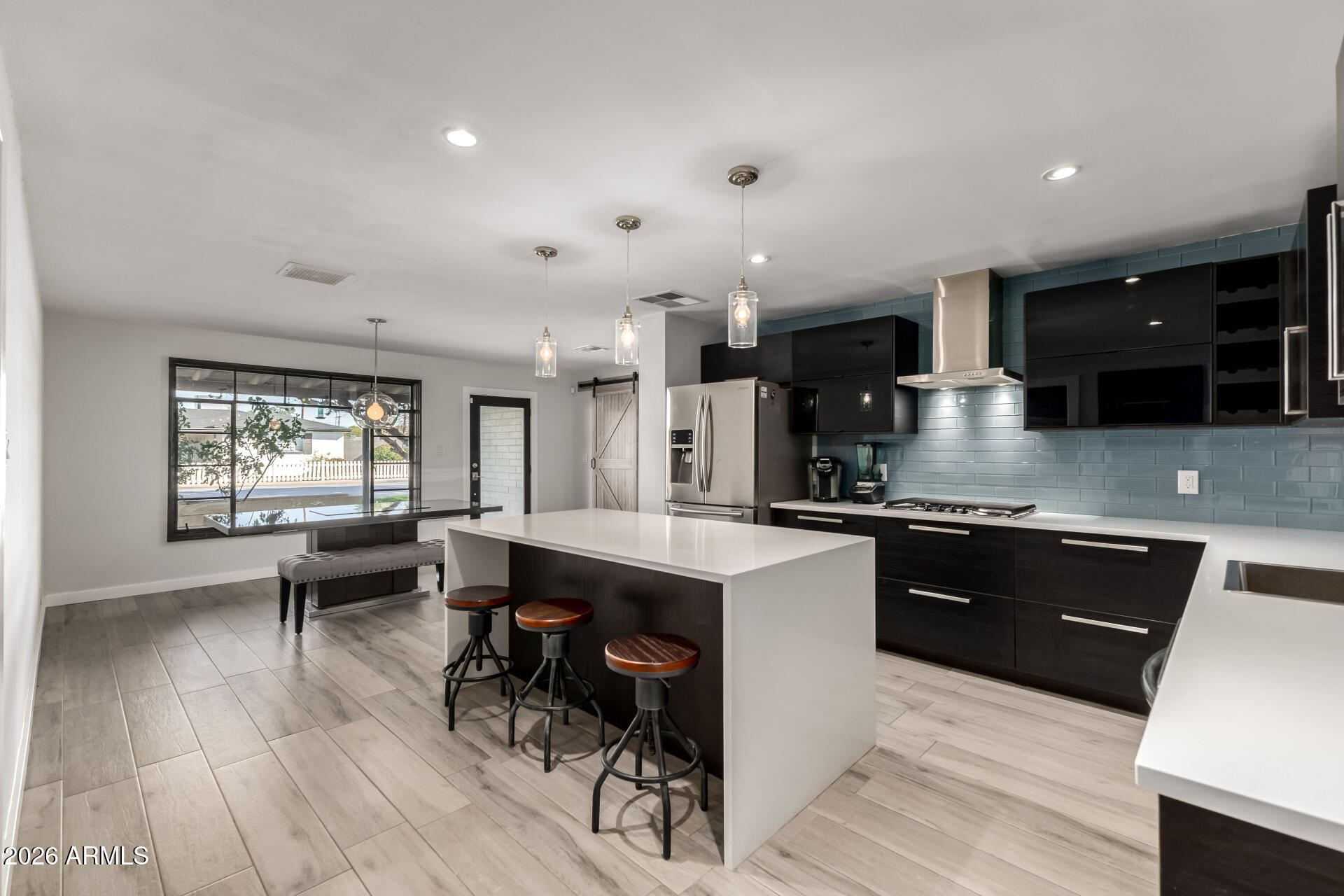 2402 North 37th Street Phoenix, AZ 85008 - Photo 10 of 44 a large kitchen with stainless steel appliances kitchen island granite countertop a large island in the center
