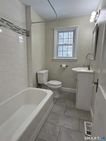 a bathroom with a sink a toilet and a bathtub