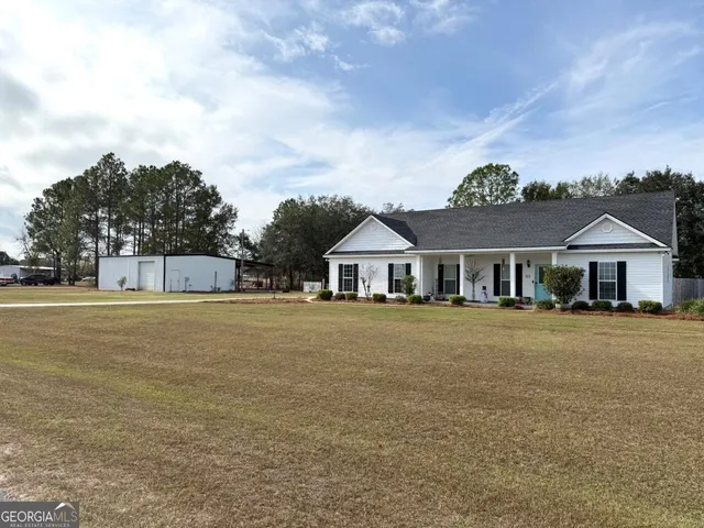 a front view of a house with a garden and deck