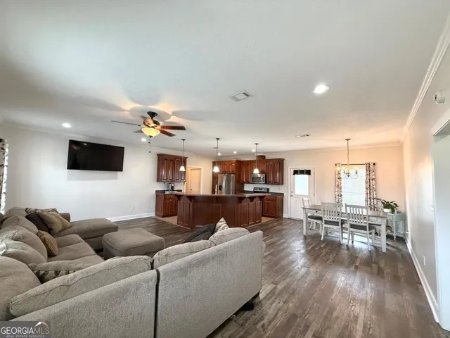 a living room with furniture and wooden floor