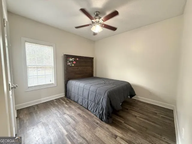 a bedroom with a bed and a ceiling fan