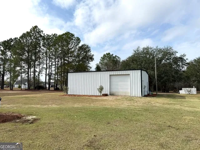 a backyard of a house with lots of green space and trampoline