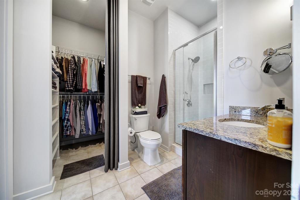 2116 McClintock Road, Unit 122 Charlotte, NC 28205 - Photo 12 of 27 a bathroom with a granite countertop sink toilet and shower