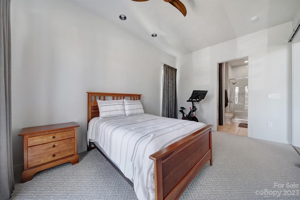 2116 McClintock Road, Unit 122 Charlotte, NC 28205 - Photo 14 of 27 a bedroom with a bed and a dresser