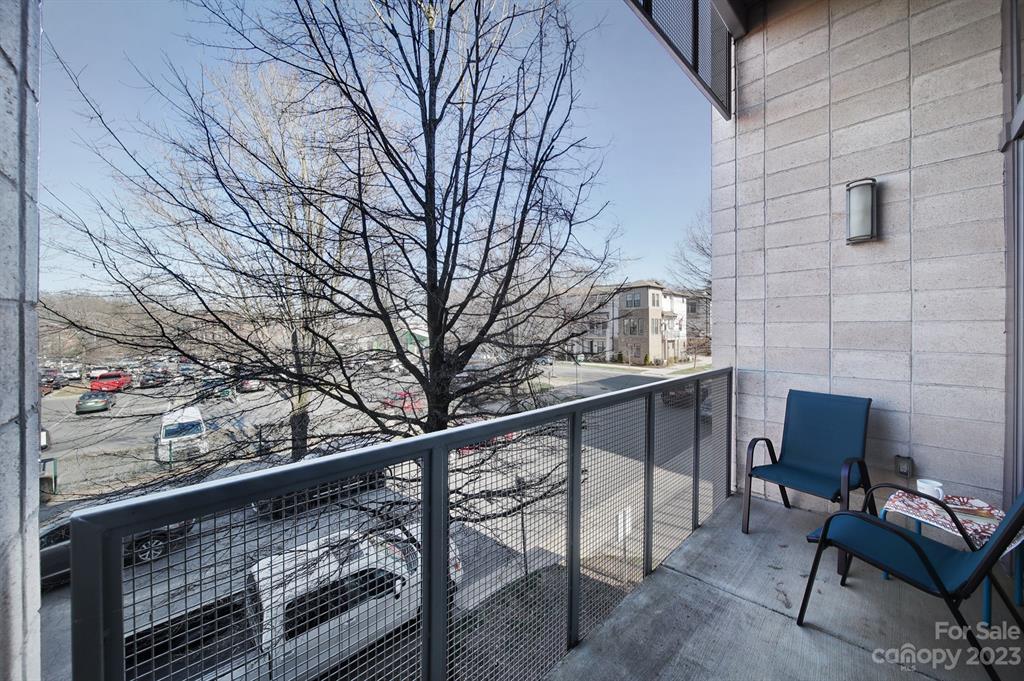 2116 McClintock Road, Unit 122 Charlotte, NC 28205 - Photo 18 of 27 a view of balcony with two chairs and a fireplace