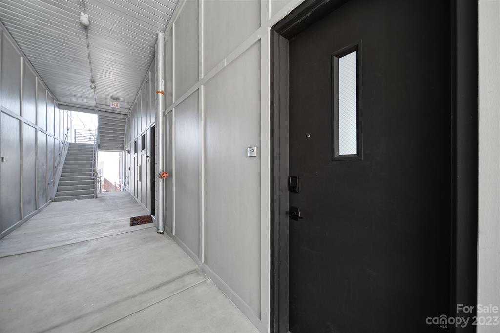 2116 McClintock Road, Unit 122 Charlotte, NC 28205 - Photo 21 of 27 a view of a hallway with wooden shelves