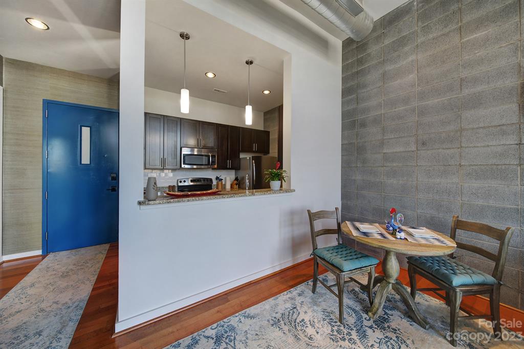 2116 McClintock Road, Unit 122 Charlotte, NC 28205 - Photo 7 of 27 a kitchen with a dining table chairs and refrigerator