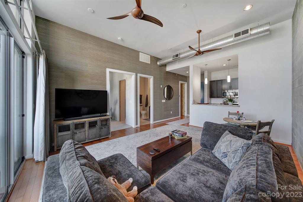 2116 McClintock Road, Unit 122 Charlotte, NC 28205 - Photo 9 of 27 a living room with furniture and a flat screen tv