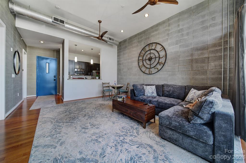2116 McClintock Road, Unit 122 Charlotte, NC 28205 - Photo 10 of 27 a living room with furniture and a clock