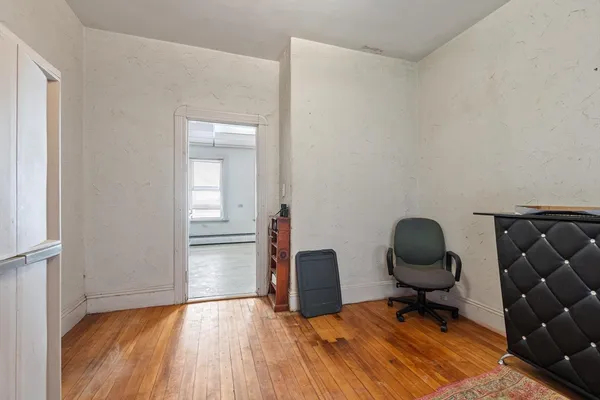 a view of workspace with wooden floor lounge chair and windows