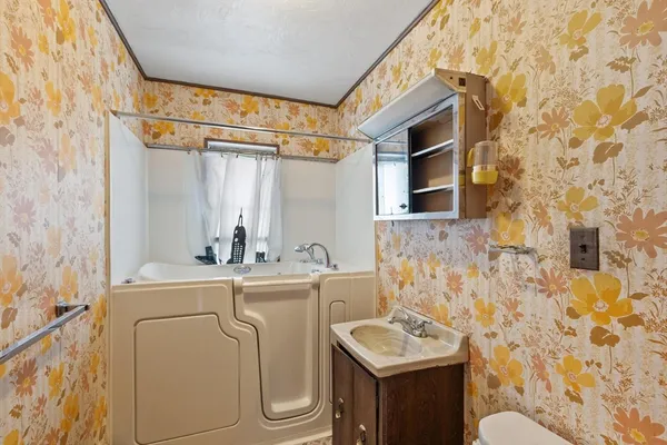 a bathroom with a sink toilet and shower