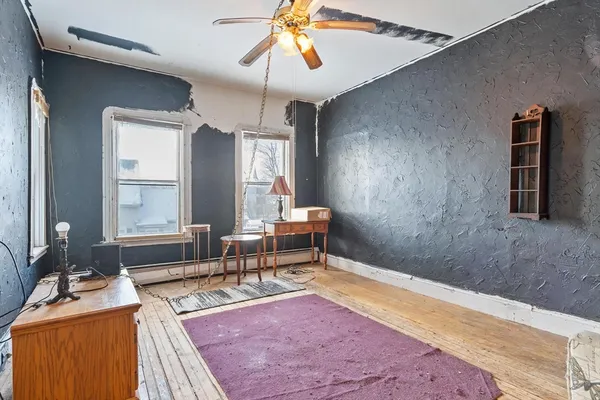 a living room with a couch and chandelier