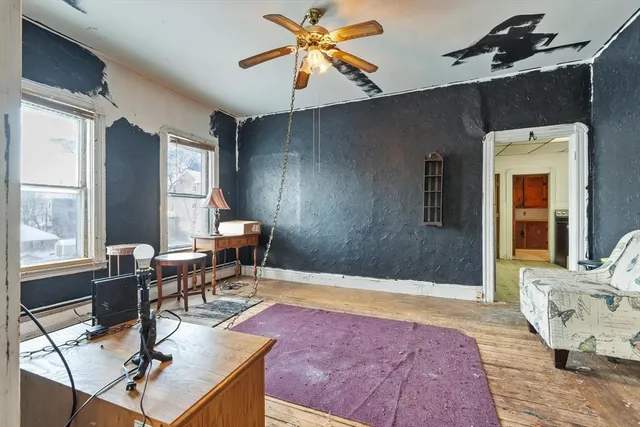 a living room with patio furniture and a dining table