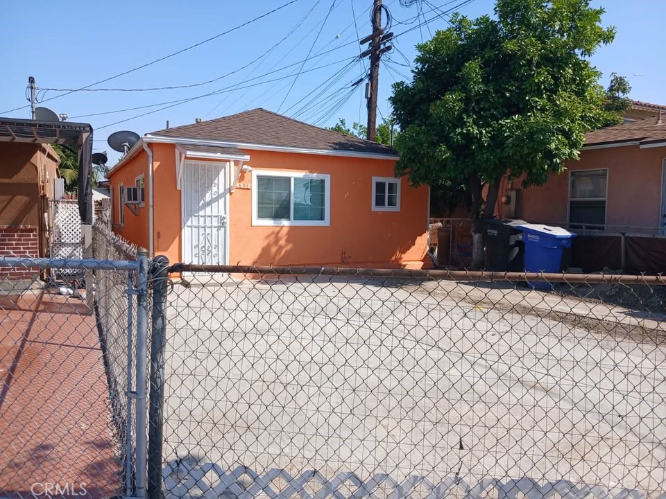 4912 Astor Avenue Commerce, CA 90040 - Photo 2 of 13 a front view of a house with a yard