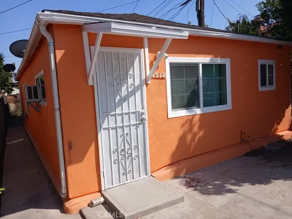 a view of a house with a door and wooden floor