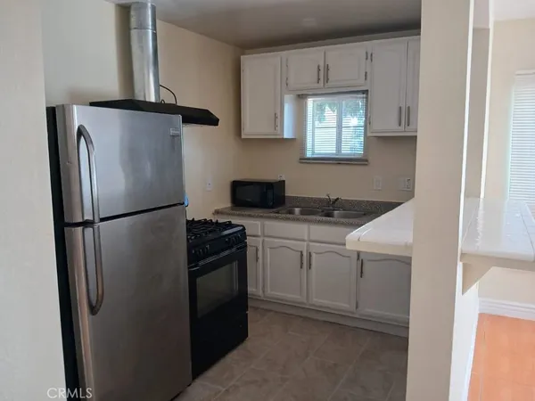 a kitchen with white cabinets