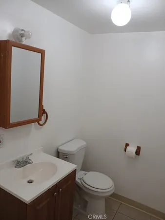 a bathroom with a sink vanity granite tub shower and a mirror
