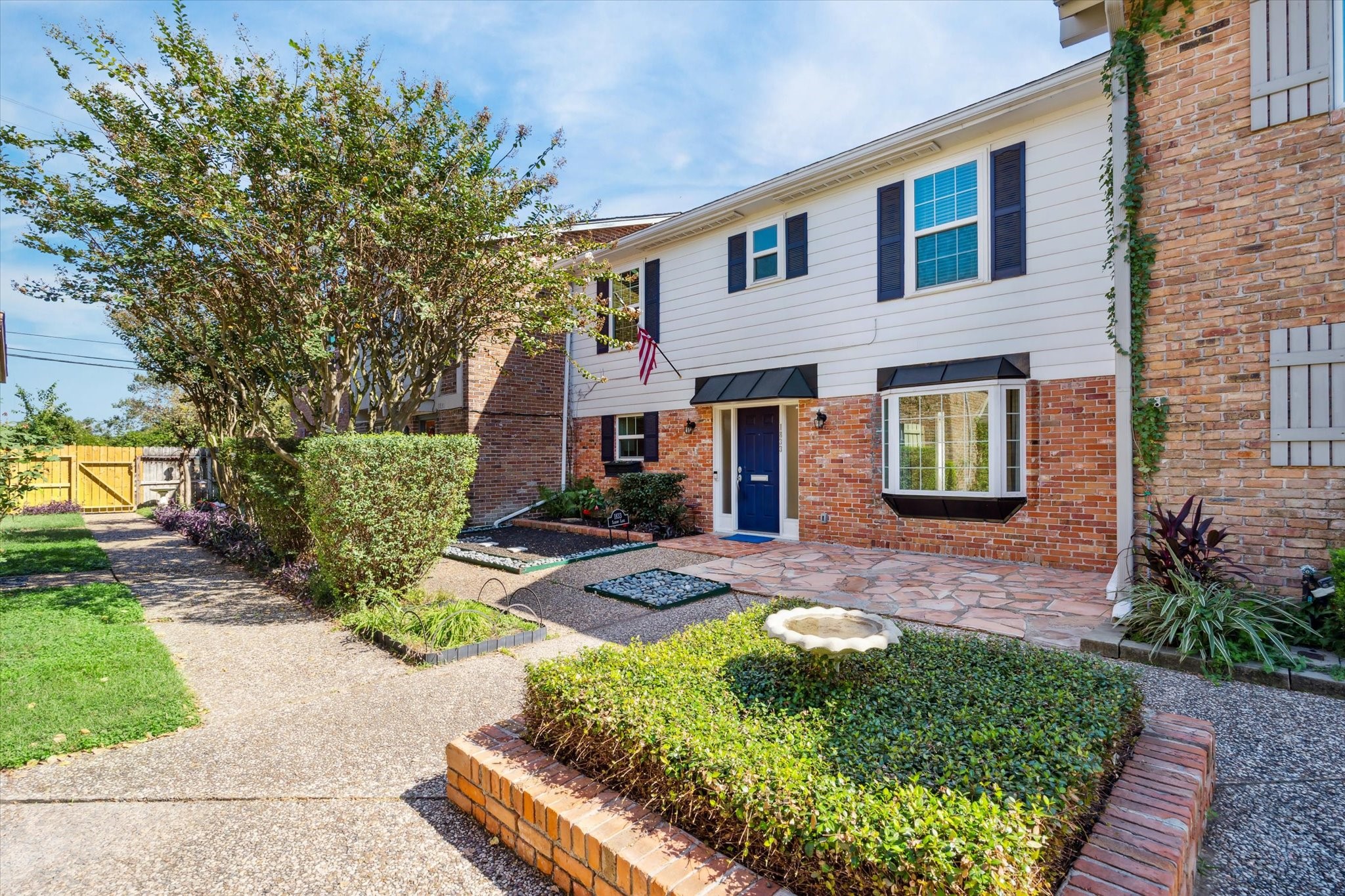 a front view of a house with garden