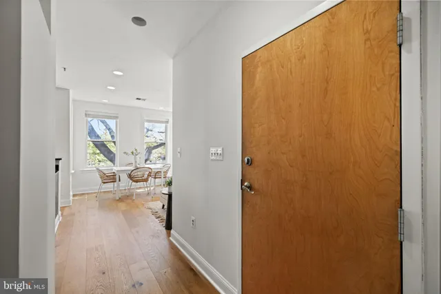 a view of a bedroom with wooden floor and furniture