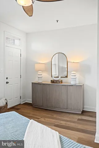 a view of a bedroom with wooden floor