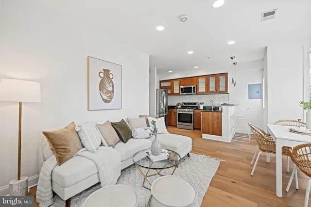 a living room with furniture and kitchen view
