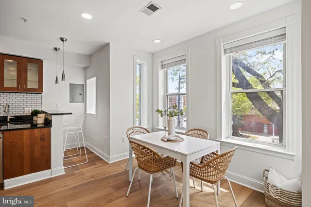 a dining room with furniture window wooden floor