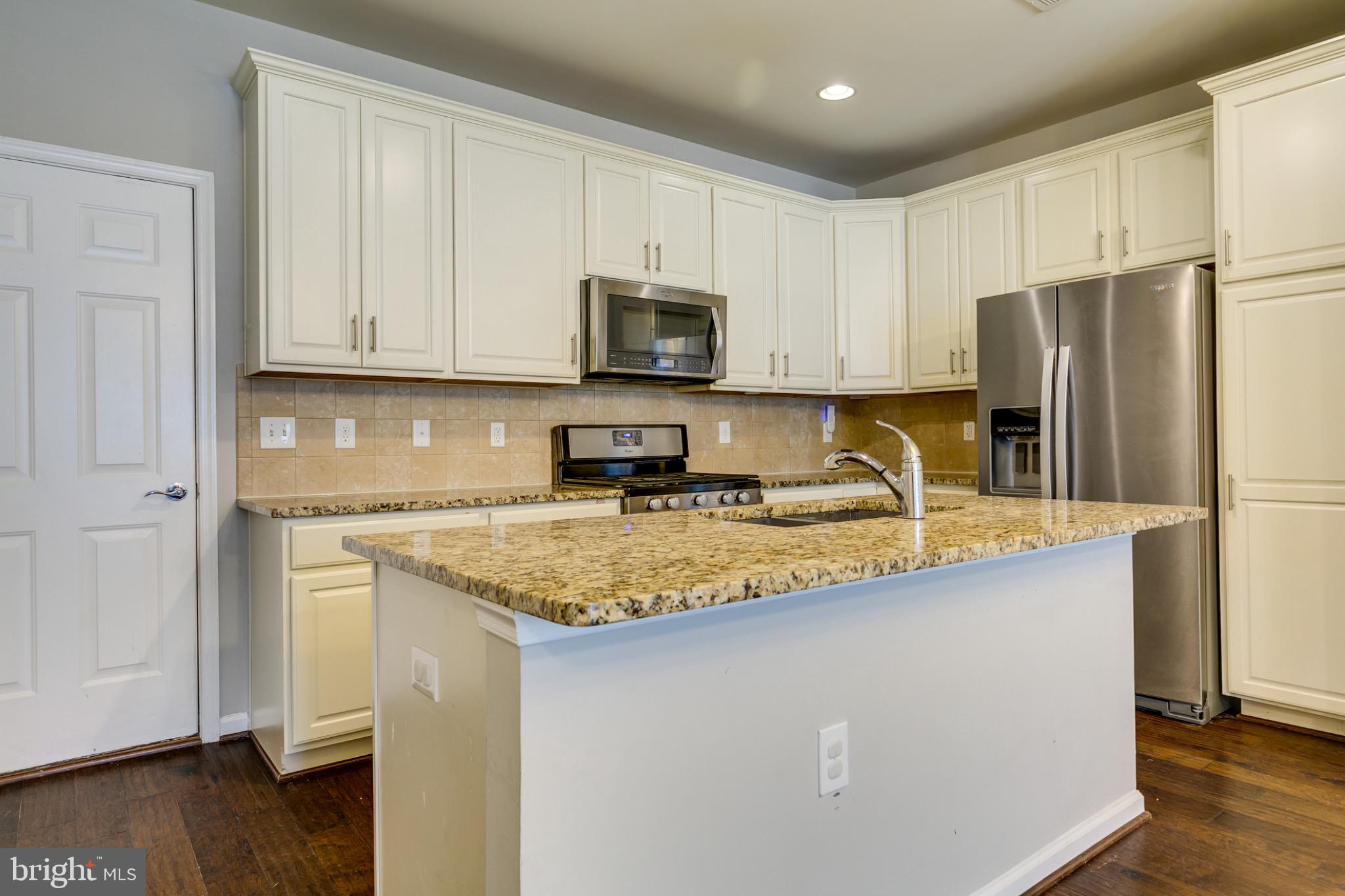 20581 Geddes Terrace Ashburn, VA 20147 - Photo 11 of 37 a kitchen with stainless steel appliances granite countertop a refrigerator a stove a sink a microwave and cabinets