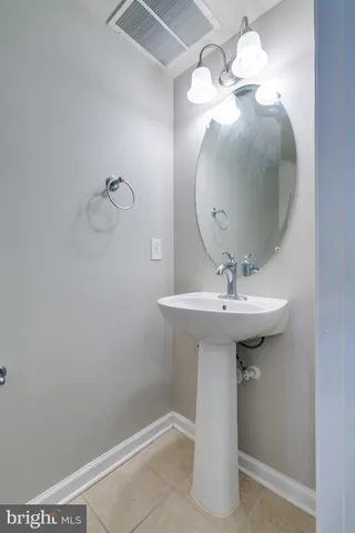 a bathroom with a sink a mirror and vanity