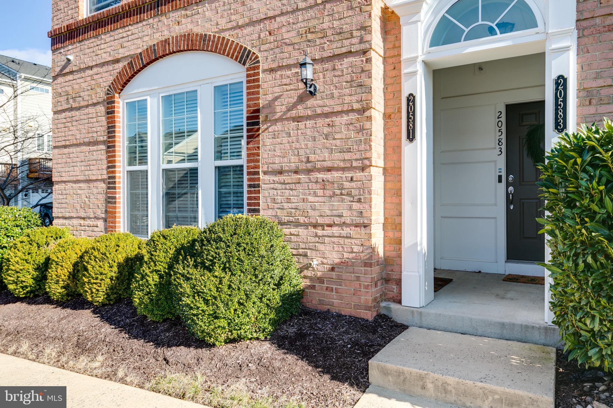 20581 Geddes Terrace Ashburn, VA 20147 - Photo 2 of 37 a view of a brick house with potted plants
