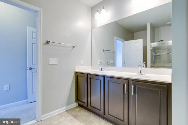 a bathroom with a double vanity sink and mirror