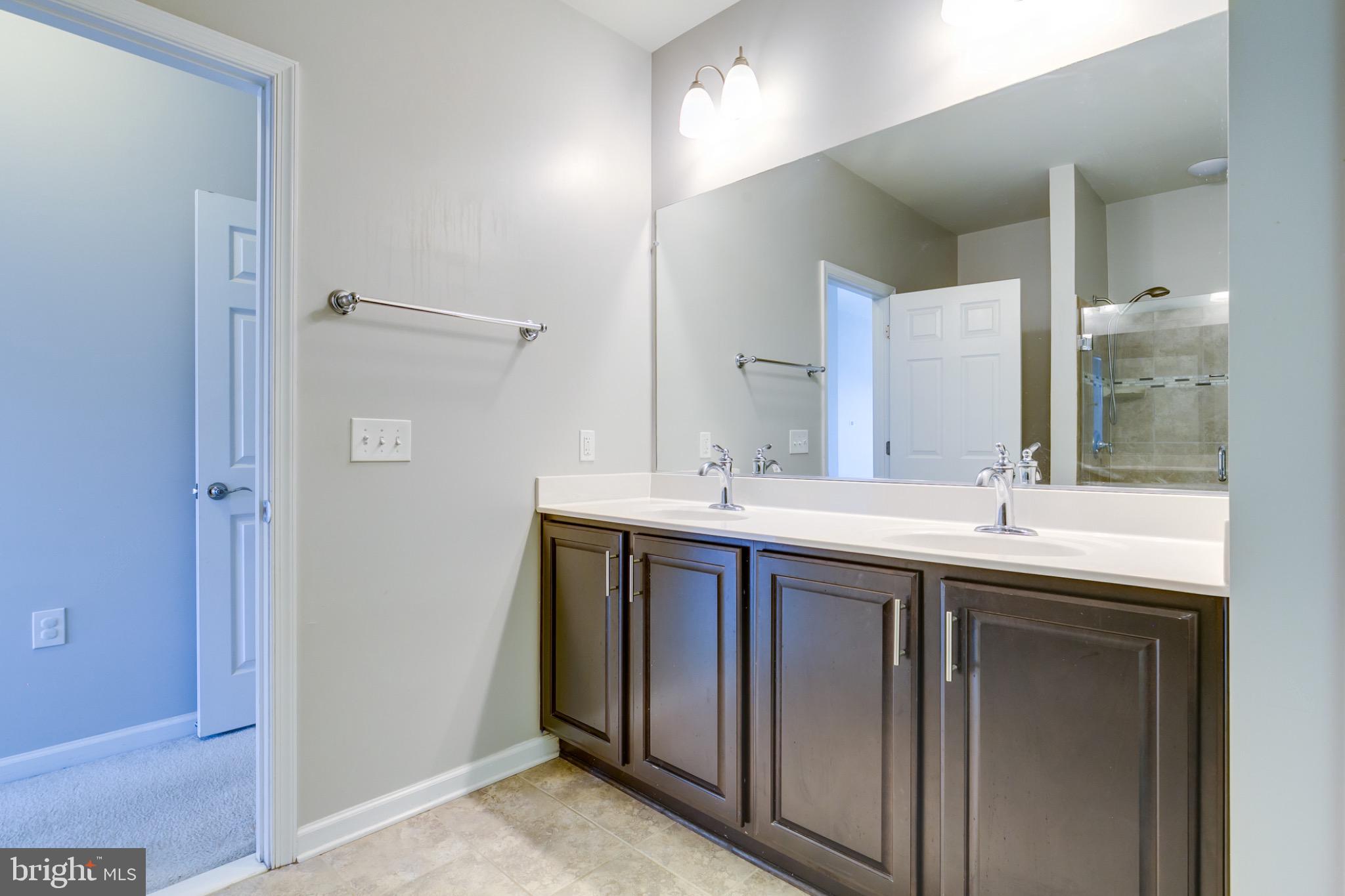 20581 Geddes Terrace Ashburn, VA 20147 - Photo 23 of 37 a bathroom with a double vanity sink and mirror
