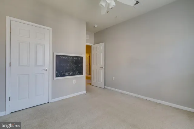 an empty room with windows and closet