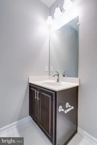 a bathroom with a sink vanity and a mirror