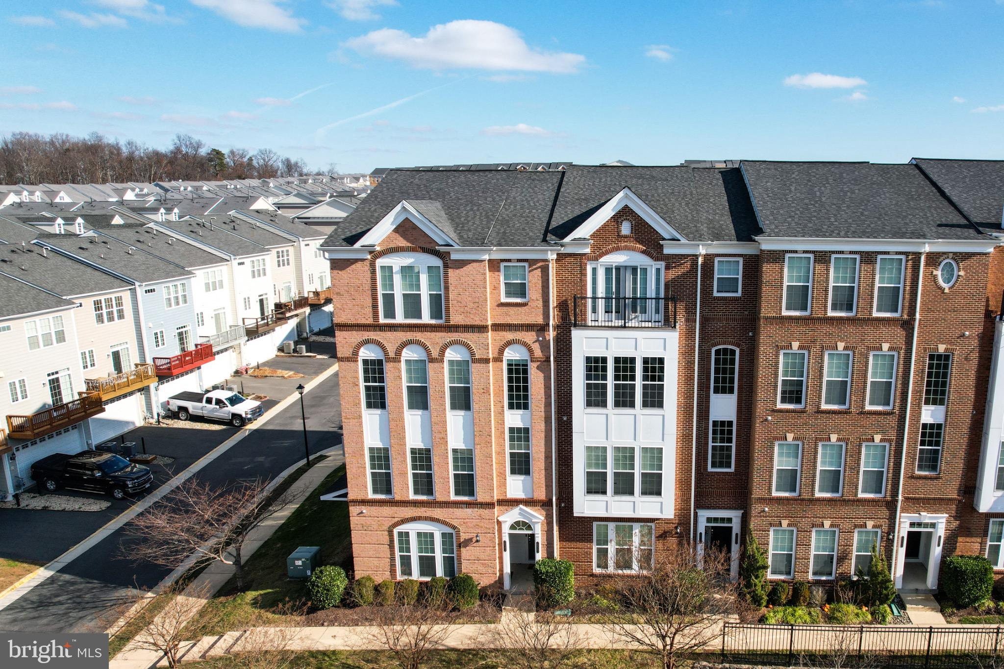 20581 Geddes Terrace Ashburn, VA 20147 - Photo 35 of 37 a front view of a residential apartment building with a yard