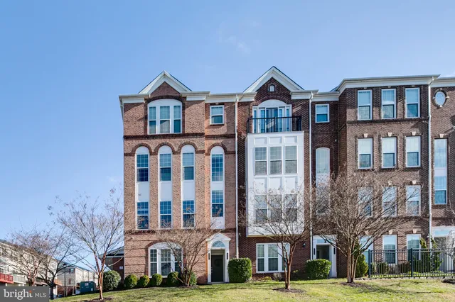 a view of a brick building next to a yard