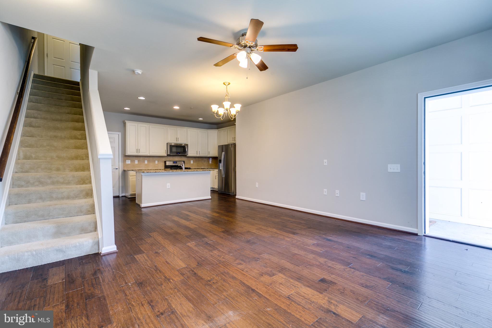 20581 Geddes Terrace Ashburn, VA 20147 - Photo 5 of 37 a view of an empty room with a kitchen and wooden floor