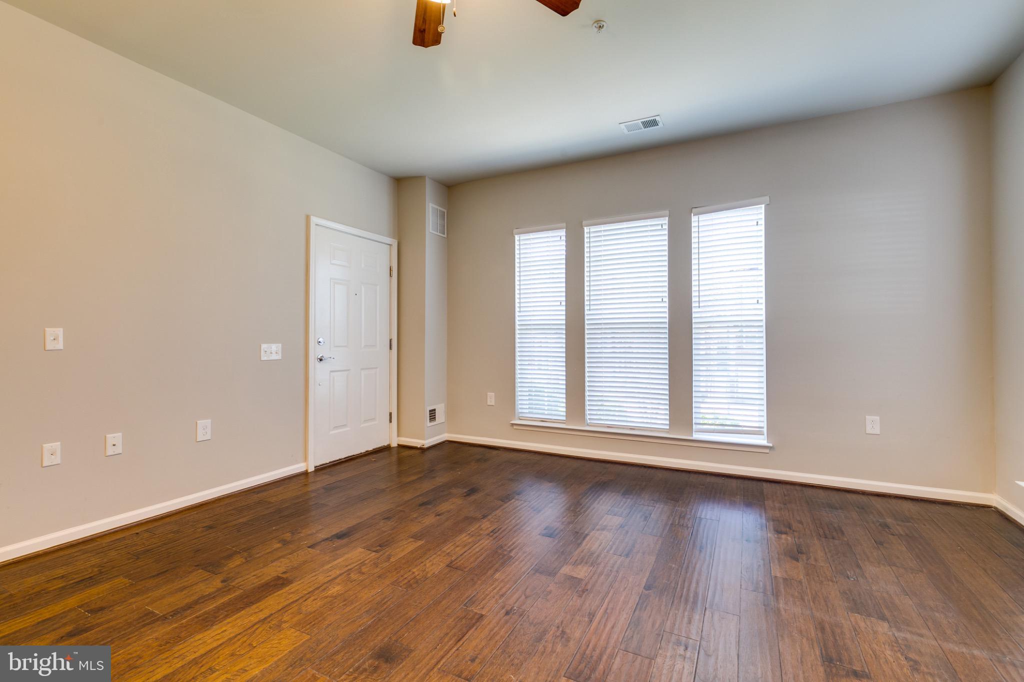 20581 Geddes Terrace Ashburn, VA 20147 - Photo 7 of 37 a view of an empty room with wooden floor and a window