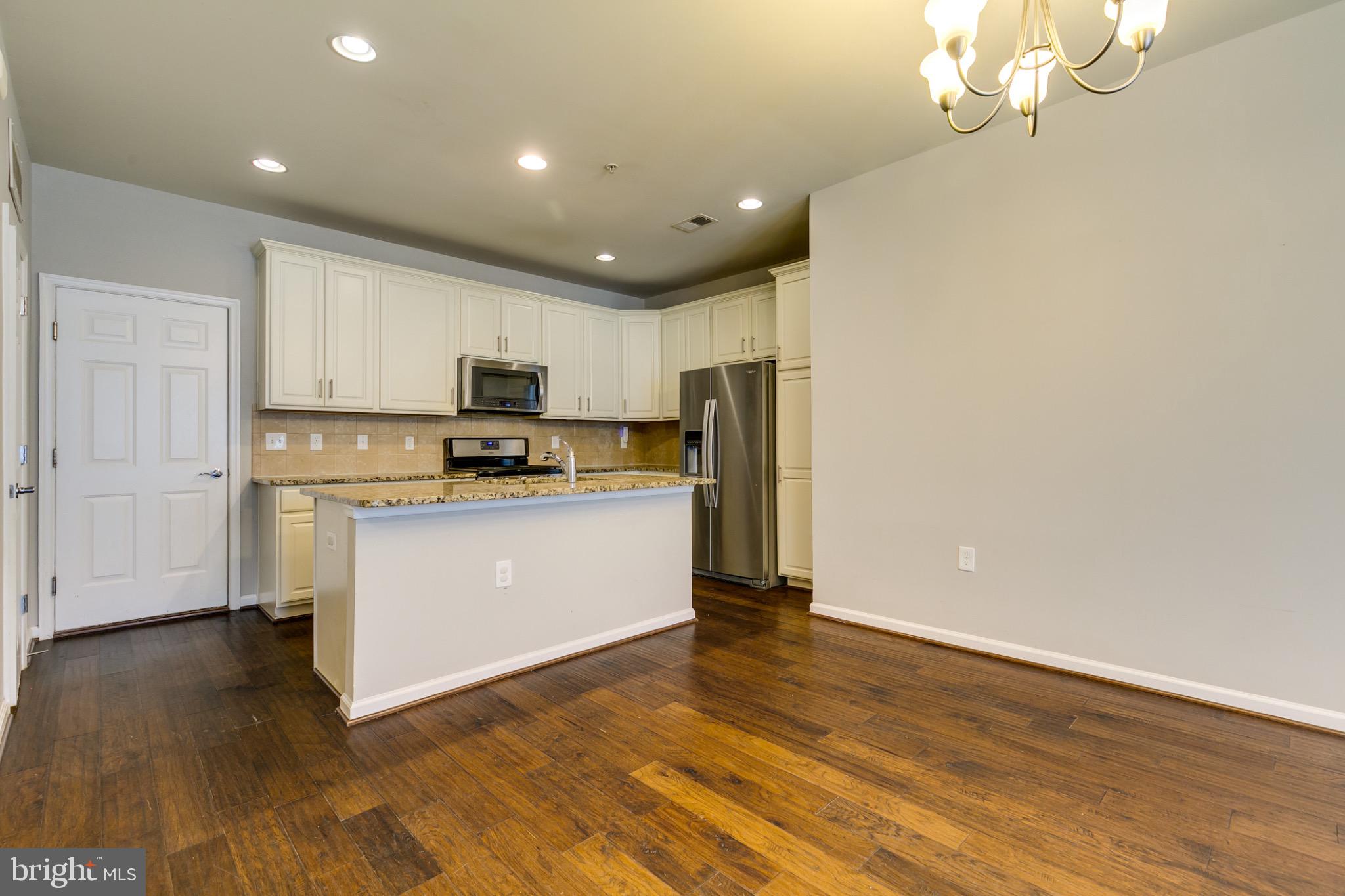 20581 Geddes Terrace Ashburn, VA 20147 - Photo 8 of 37 a kitchen with granite countertop white cabinets and stainless steel appliances