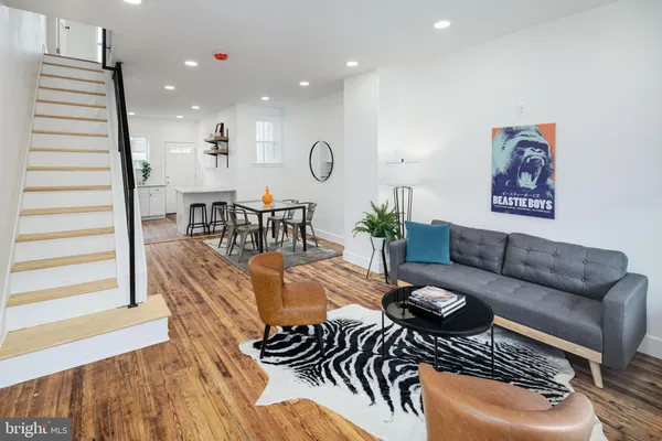 a living room with furniture and wooden floor