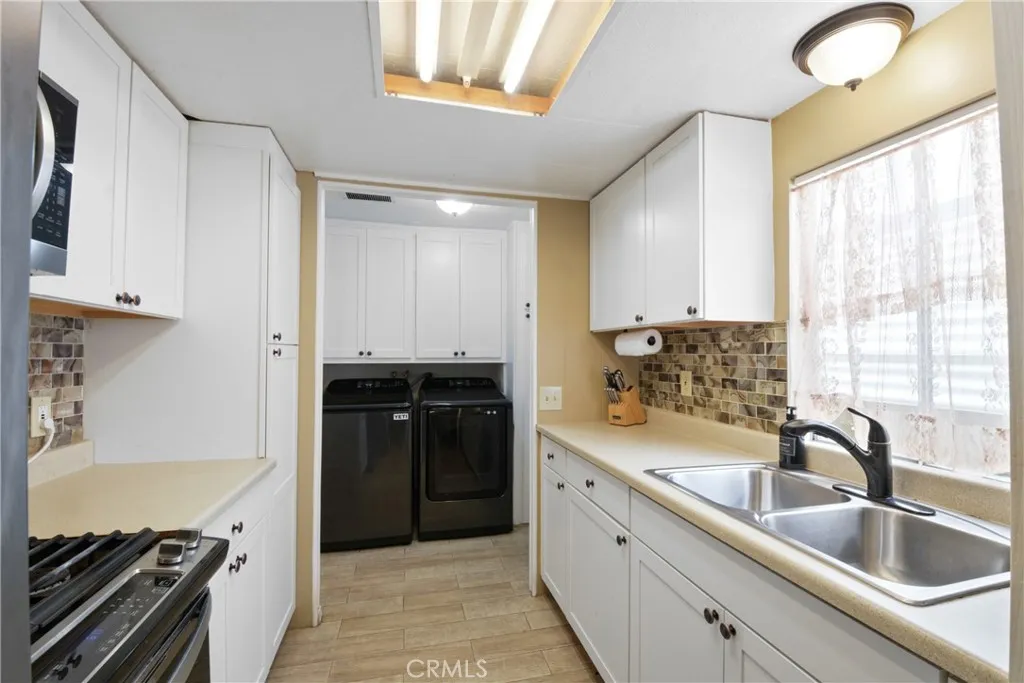 23701 South Western Avenue, Unit 197 Torrance, CA 90501 - Photo 13 of 32 a kitchen with a sink stove and refrigerator