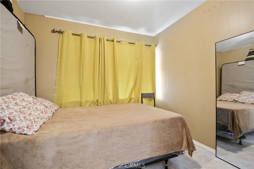 23701 South Western Avenue, Unit 197 Torrance, CA 90501 - Photo 14 of 32 a bedroom with a bed and a chair