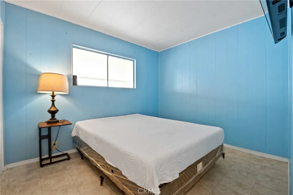 23701 South Western Avenue, Unit 197 Torrance, CA 90501 - Photo 17 of 32 a bedroom with a bed and a table in it