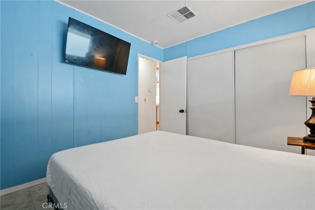 23701 South Western Avenue, Unit 197 Torrance, CA 90501 - Photo 18 of 32 a bedroom with a bed and a television