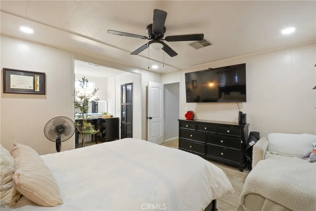 23701 South Western Avenue, Unit 197 Torrance, CA 90501 - Photo 20 of 32 a bedroom with a bed and a flat screen tv