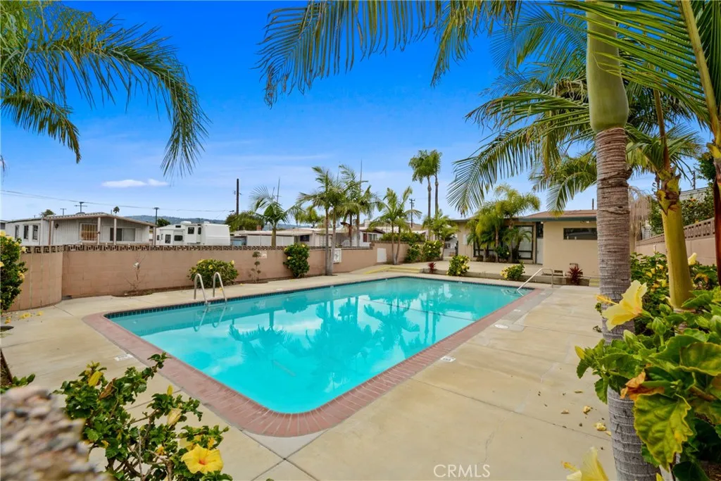 23701 South Western Avenue, Unit 197 Torrance, CA 90501 - Photo 25 of 32 a view of a swimming pool with a lawn chairs under an umbrella