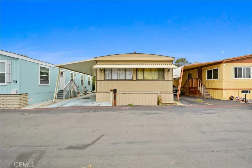 23701 South Western Avenue, Unit 197 Torrance, CA 90501 - Photo 26 of 32 a front view of a house with a yard